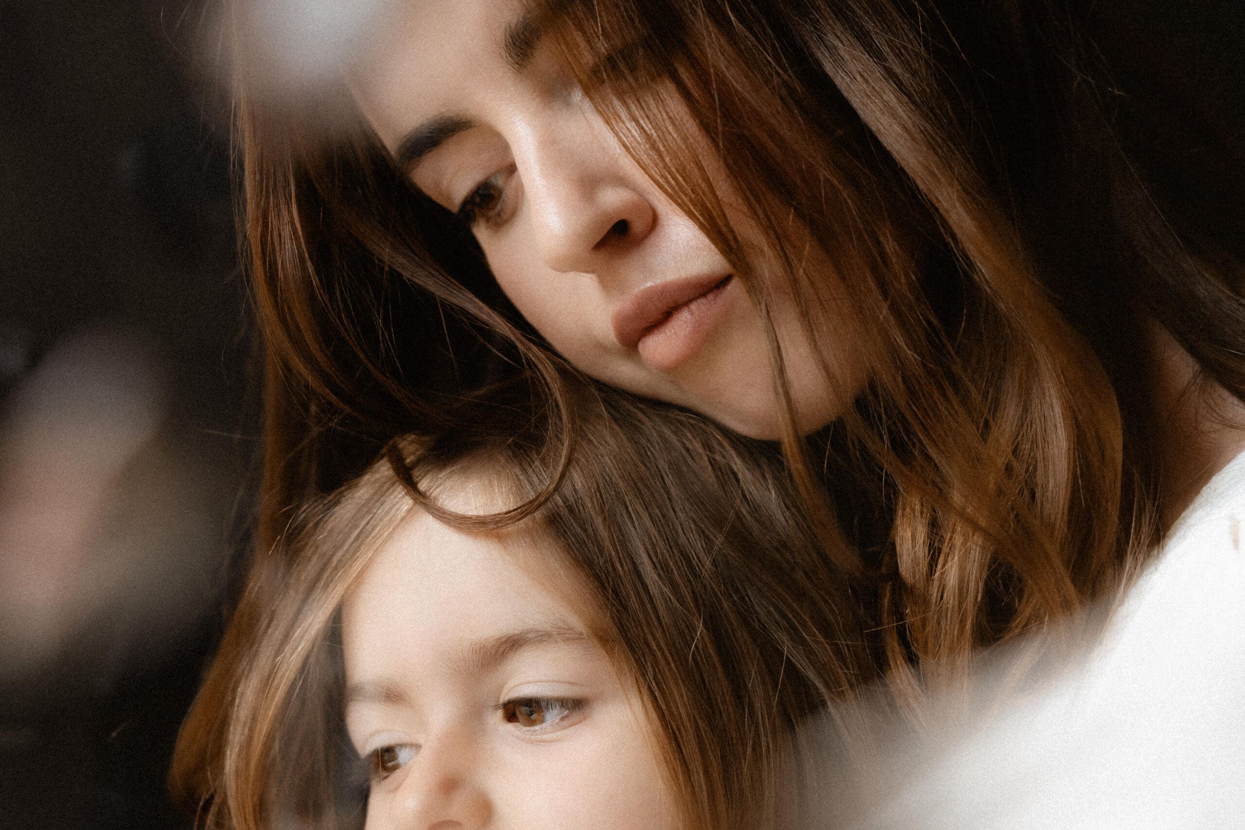 close up of mother and daughter embracing